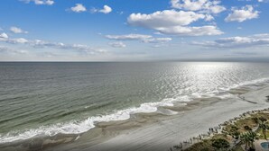 A beach with a clear sky and waves. - 🌴Stunning Ocean Views | Pools + Hot Tub | The Island 1214🌴 (Myrtle Beach)