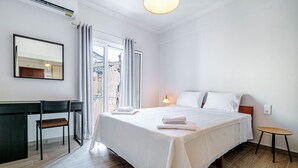 A hotel room with a bed, a desk, a chair, and a small table. - Alex Home by Corfuescapes (Corfu)