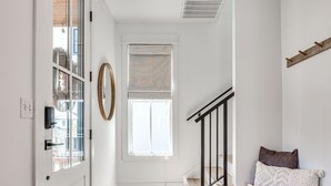 A modern interior with a staircase, a bench, and a window with blinds. - New Property in Carlton Landing-Nolan's Nook- Pet Friendly (Carlton Landing)