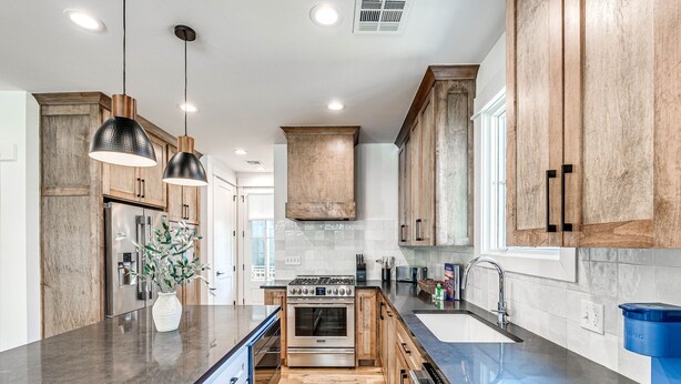 A modern kitchen with wooden cabinets, stainless steel appliances, and a central island. - New Property in Carlton Landing-Nolan's Nook- Pet Friendly (Carlton Landing)
