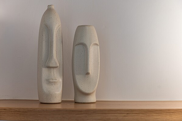 Two ceramic vases with abstract faces on a wooden shelf against a plain wall. - Carpe Diem Villa II ,Private Infinity Heated Pool! (Mykonos)