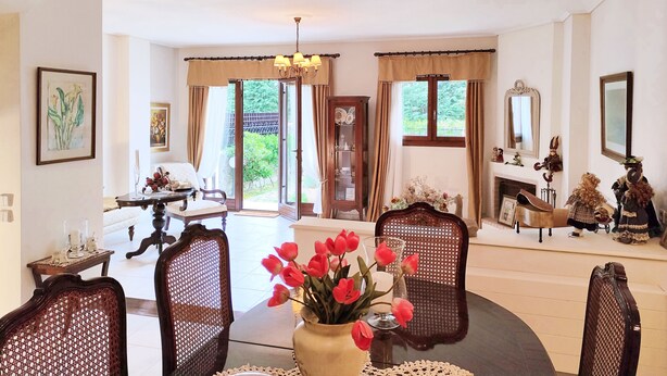 A spacious room with a chandelier, a fireplace, and a view of the outdoors. - Christie's Boutique by Corfuescapes  (Corfu)