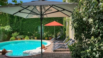 Seasonal outdoor pool, open 9:00 AM to 7:00 PM, pool umbrellas