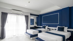 A modern hotel room with two beds, a large window with curtains, an air conditioning unit, and a blue accent wall. - The Parc Bangna (Bang Phli)