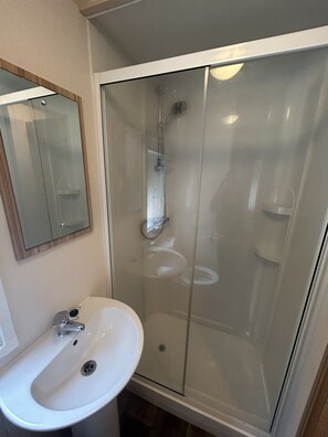 Shower, hair dryer, towels, toilet paper