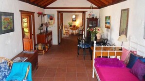 A cozy room with a bed, a desk, and a chair. There is a dining area in the background. - Casa  Grøn (CN)