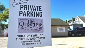 A sign for exclusive private parking at The Quarters at Mill Square, warning violators of ticketing and towing. - The Quarters | Suite 3 (Grafton)