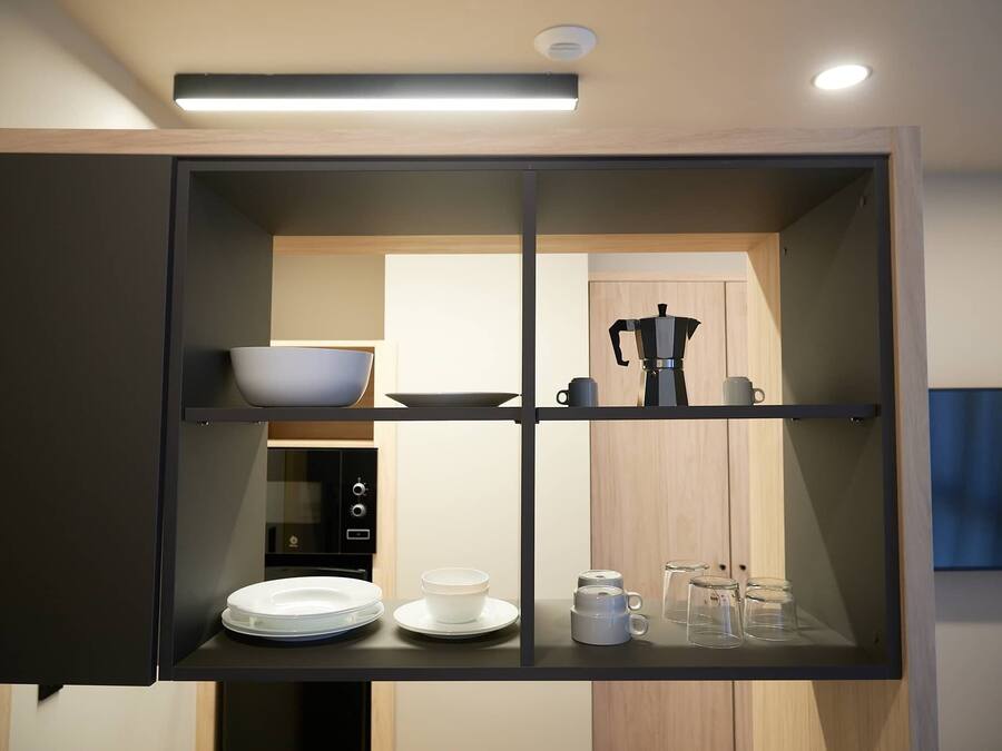 Una cocina moderna equipada con cafetera, microondas y estufa.