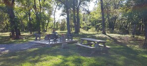 Enjoy a peaceful retreat in a serene forest setting with a picnic table and benches.