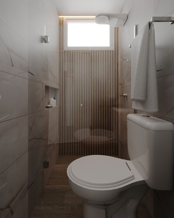 Un baño moderno con inodoro, ducha y ventana.