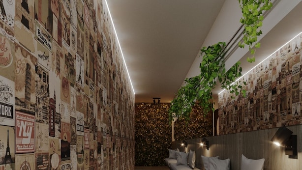 A modern interior with a wall covered in vintage travel posters, a wooden floor, and a seating area with cushions. - Itaim Internacional Stay (São Paulo)