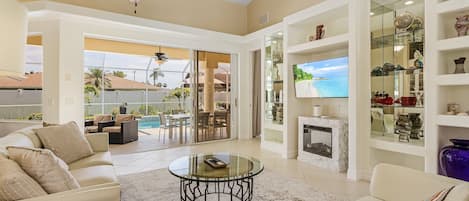 Smart TV, fireplace, books, computer monitors