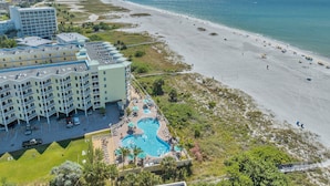 A hotel with a pool, beach, and ocean view. - AMAZING BEACH VIEW/ FULLY REMODELED CONDO/ALL NEW FURNITURE/ HEATED POOL (Treasure Island)