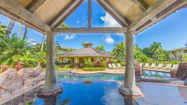 A pool area with a gazebo, palm trees, and lounge chairs. - Princeville Paradise - Luxury A/C (Princeville)