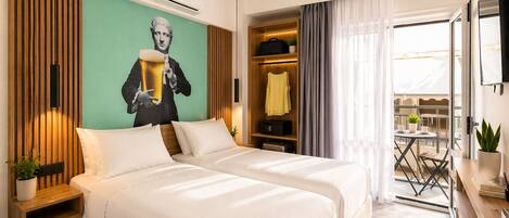 A hotel room with two beds, a mural, a wardrobe, a balcony, and a TV.
