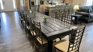A spacious kitchen with wooden cabinets, a stainless steel refrigerator, a microwave, and a coffee maker. - YES! 🎸FamilyPlace 🏊‍♀️POOL/WaterFall💦HOTTUB 🔥FIREPIT🎱POOLTABLE⚡EV🎡FUN❤️LUV (Branson)