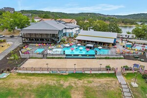 Un resort con piscina, zona de estar al aire libre y vistas al lago.