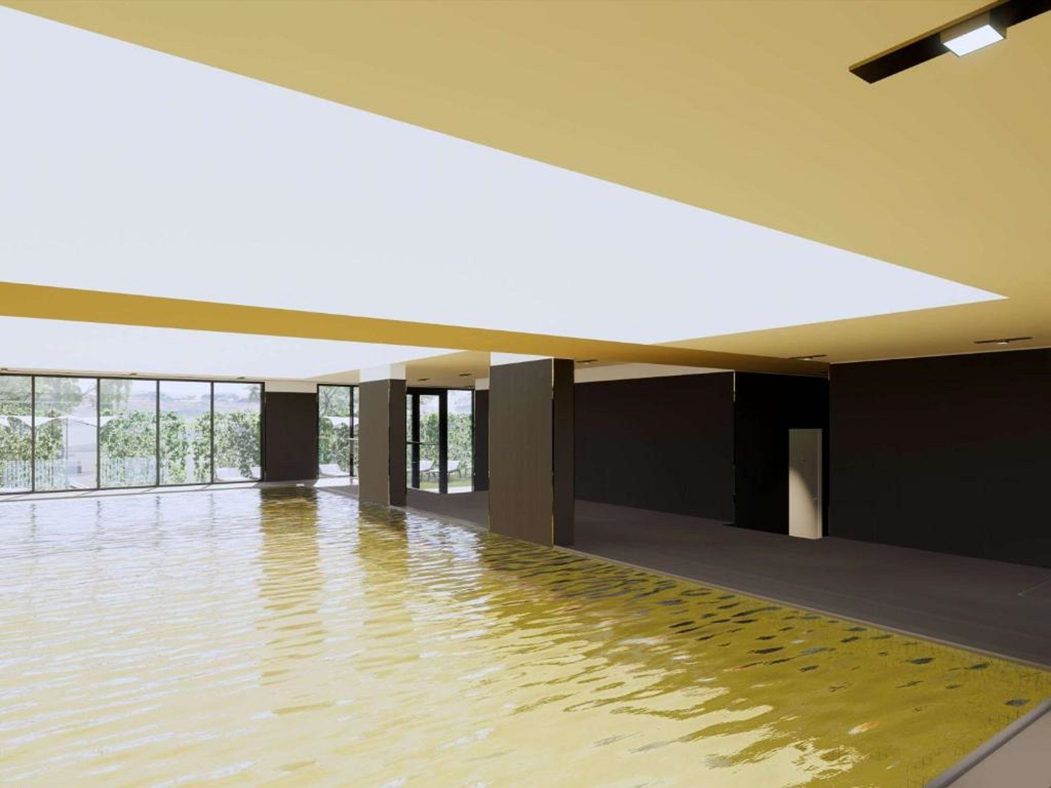 A spacious indoor area with a reflective floor, large windows, and a high ceiling.