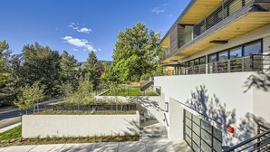 A modern building with a staircase, outdoor seating, and a view of trees and mountains. - Luxurious Rental with Ideal Downtown Proximity - Stroll to Pearl Street and CU. (Boulder)