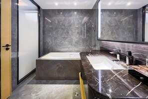 A modern bathroom with a large bathtub, a separate shower area, and a vanity with a mirror. - Grand Madison Jingzhong Yuci Haitangwan (Jinzhong)
