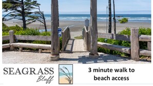 A wooden pergola with a beach view, a sign indicating a 3-minute walk to beach access, and the Seagrass Bluff logo. - Oceanside - Dog Friendly - 3pm Checkout   (Pacific Beach)