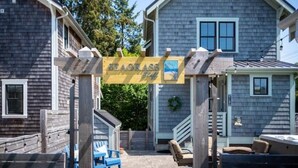 A two-story house with a wooden deck and a sign that reads "SEAGGASS." - Oceanside - Dog Friendly - 3pm Checkout   (Pacific Beach)