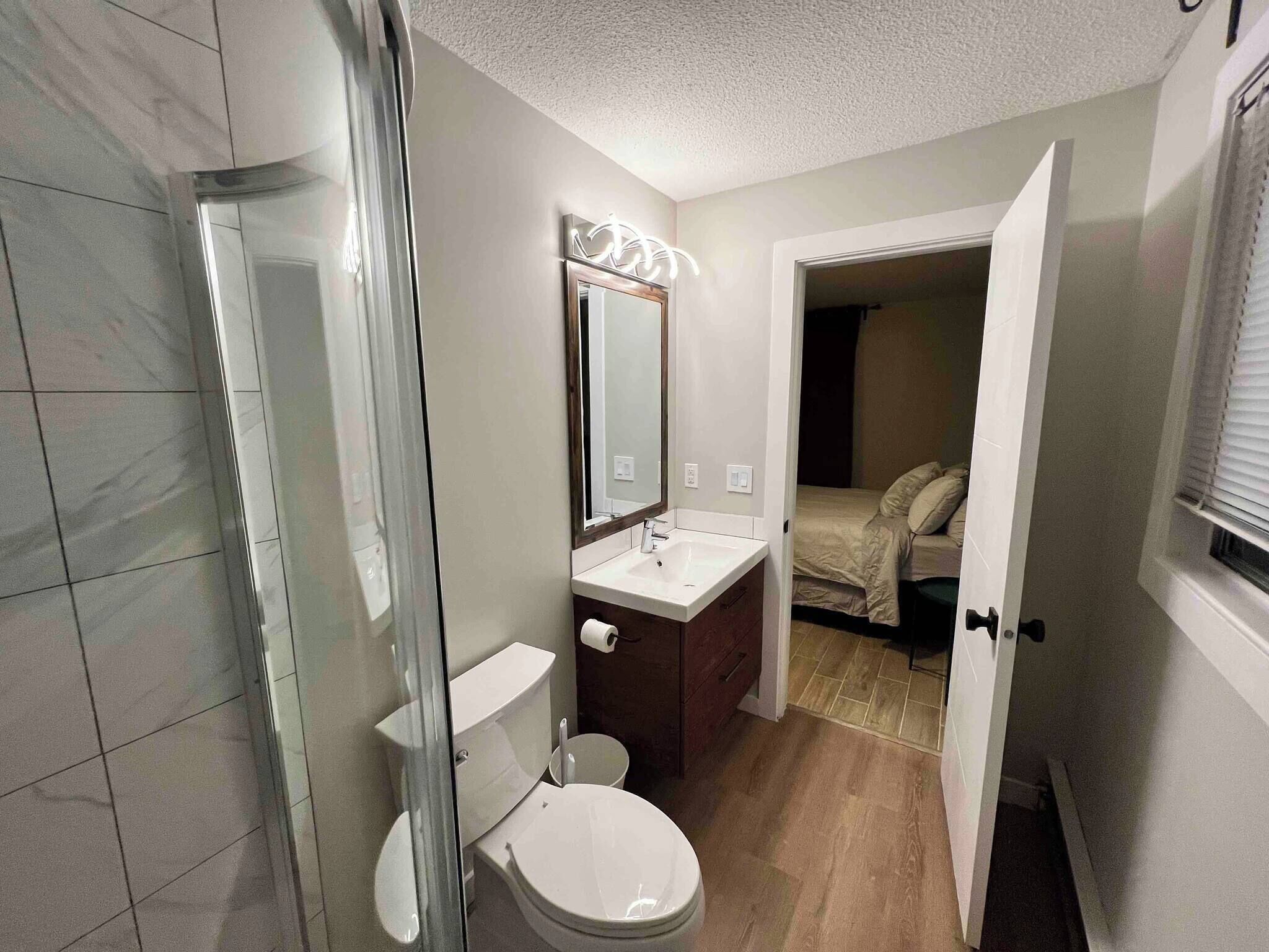 Un baño con inodoro, lavabo y espejo.