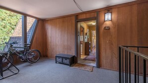 A wooden exterior with a number '30' sign, a bicycle, and a small bench. - Palisades Tahoe Condo~Walk to the Village~(#30) (Olympic Valley)