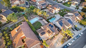 An aerial view of a residential area with houses, solar panels, and a swimming pool. - Spacious 4-bedroom suburban retreat in San Diego! Backyard, BBQ, Pool & Jacuzzi  (San Diego)