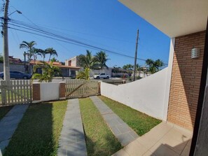 Enjoy a serene outdoor space with a paved patio, grassy area, and walkway.