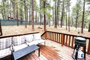A deck with a sofa and a grill. - Grand Gateway Cabin | 1-Acre Pine Retreat, Rt. 66 (Williams)