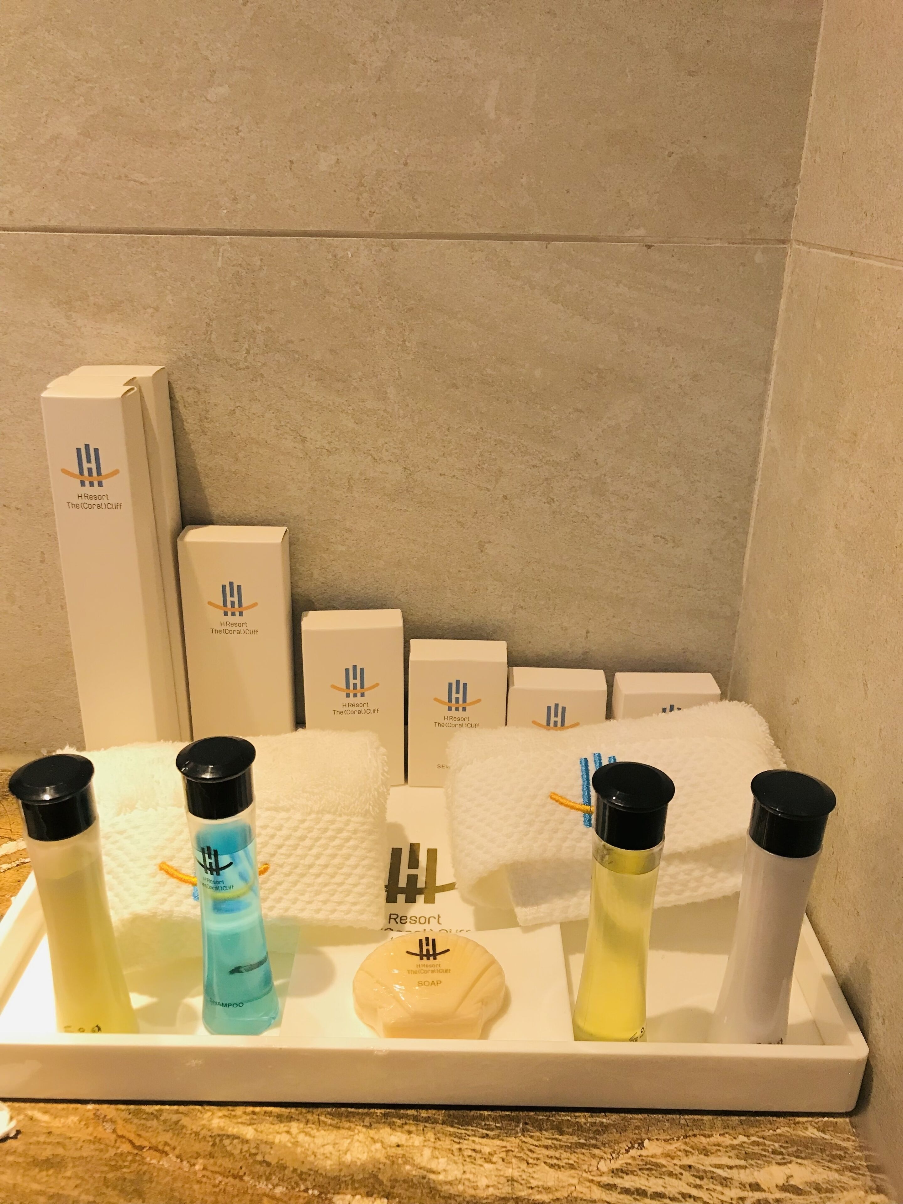 A hotel bathroom with toiletries arranged on a tray.