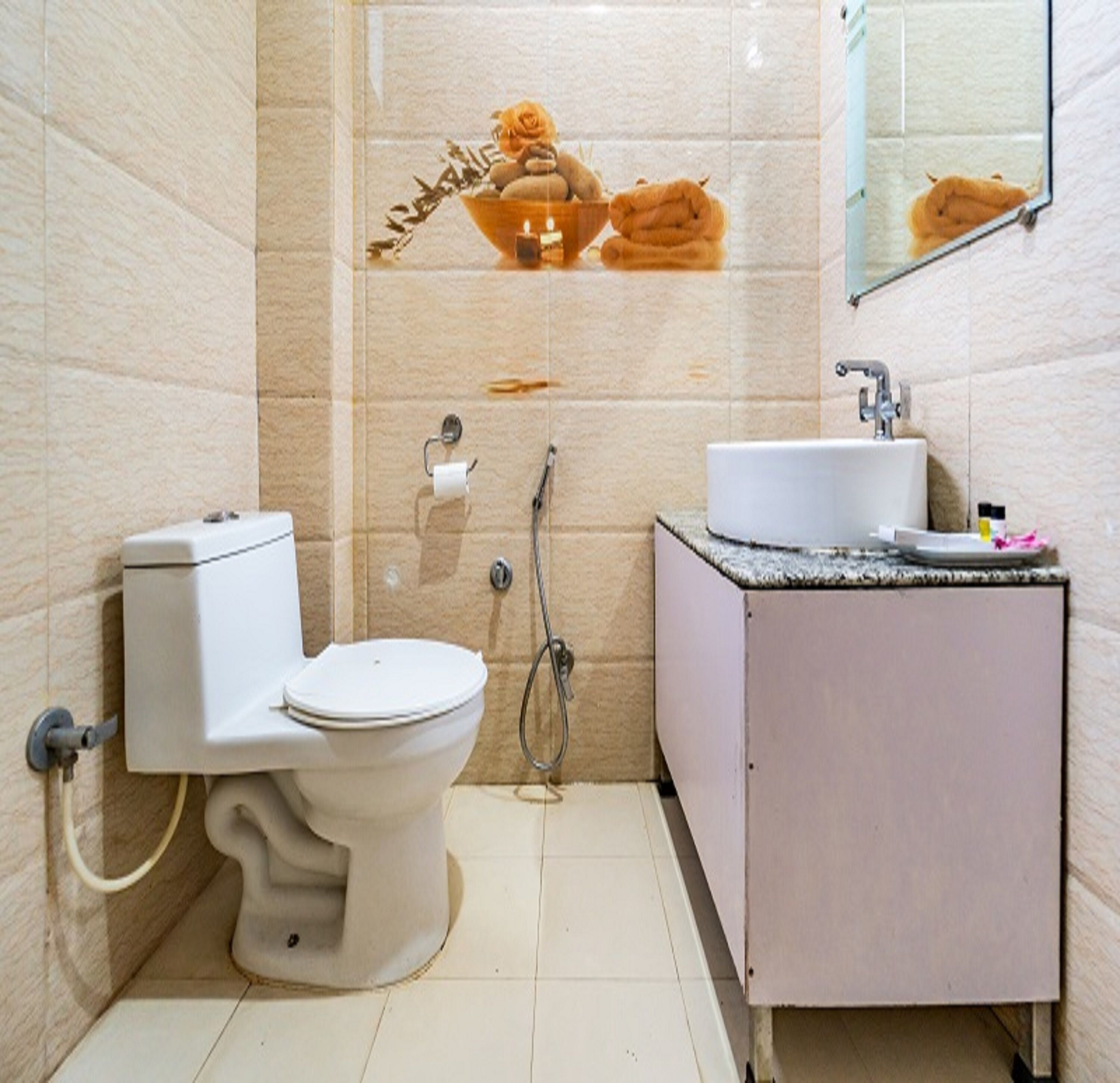 A bathroom with a toilet, sink, and shower.