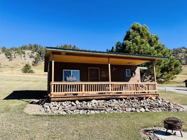 Enjoy a peaceful retreat in this cabin with a porch, fireplace, and serene surroundings.