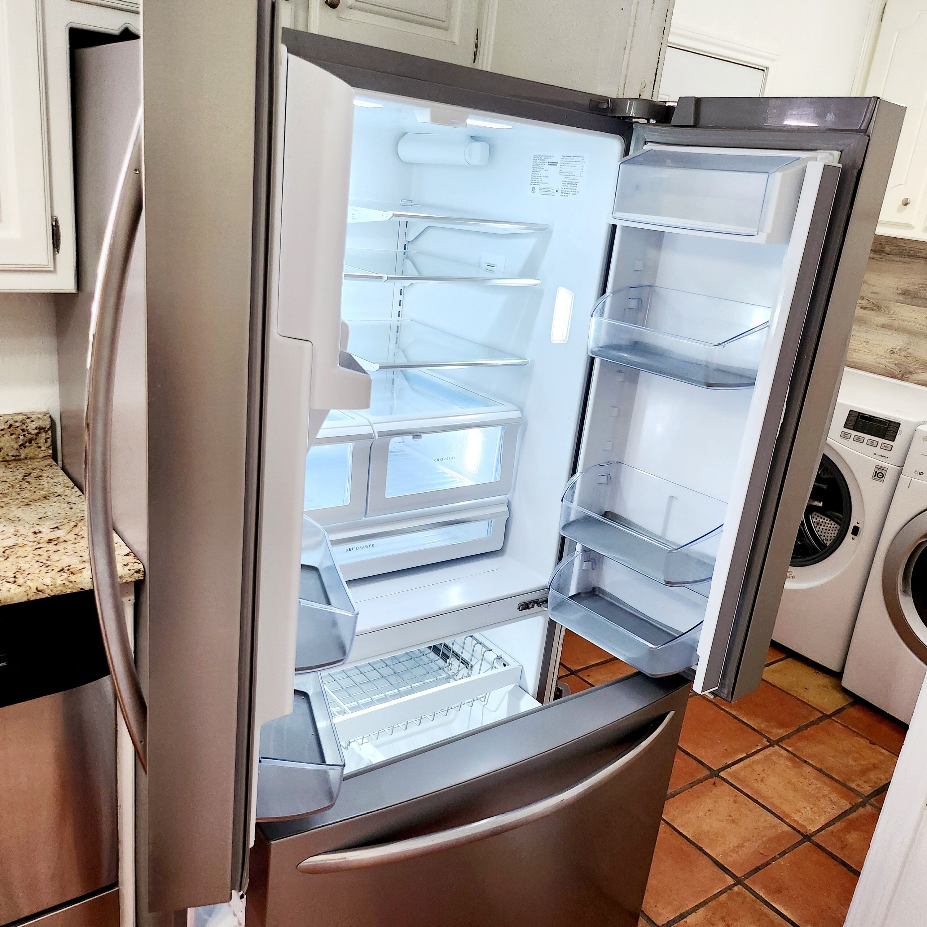A stainless steel refrigerator with a freezer compartment, a built-in ice maker, and a water dispenser.