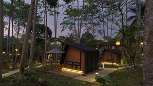 A modern eco-friendly resort with treehouse-style cabins, outdoor seating, and ambient lighting. - Bobocabin The Tavia Puncak (Megamendung)