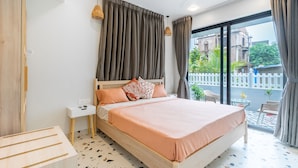 A bedroom with a bed, bedside table, and a view of the outside. - Villa Reverie 6 Bedroom Ultra Modern (Betalbatim)