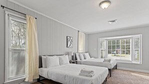 A hotel room with two beds, a large window, and a ceiling light. - 15 Minutes from Downtown! Welcome to Woodbridge (Montgomery)