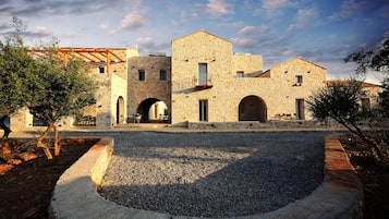 A stone building with multiple arches and a courtyard.