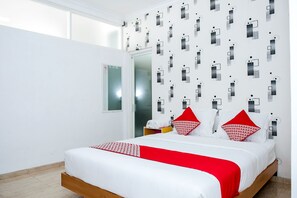 A modern hotel room with a large bed, white walls, and a patterned wallpaper. - Hotel O 111 Residence (Batu)