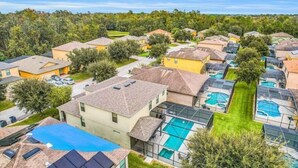 A residential area with houses, a swimming pool, and a tennis court.