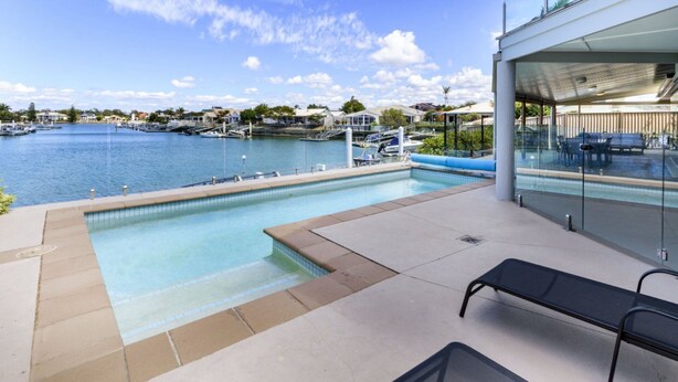 A pool area with a view of the marina and boats.