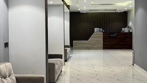 A modern lobby with a reception desk, seating area, and a marble floor. - QIMAM PARK 4 Abha (Abha)