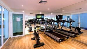 A gym with treadmills, stationary bikes, and weight machines. - Apartment at Kata Ocean View by Lofty (Karon)