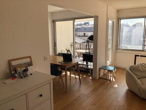 Work, relax, and unwind in this apartment with a functional layout, featuring a dining area, cozy seating, and a balcony with city views.