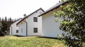 A modern two-story building with a flat roof and white exterior walls.