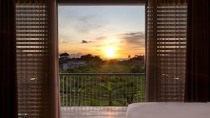 A bedroom with a view of a sunset over a rural landscape. - Best Seller 2 Bedrooms Villa in Central Seminyak (Seminyak)