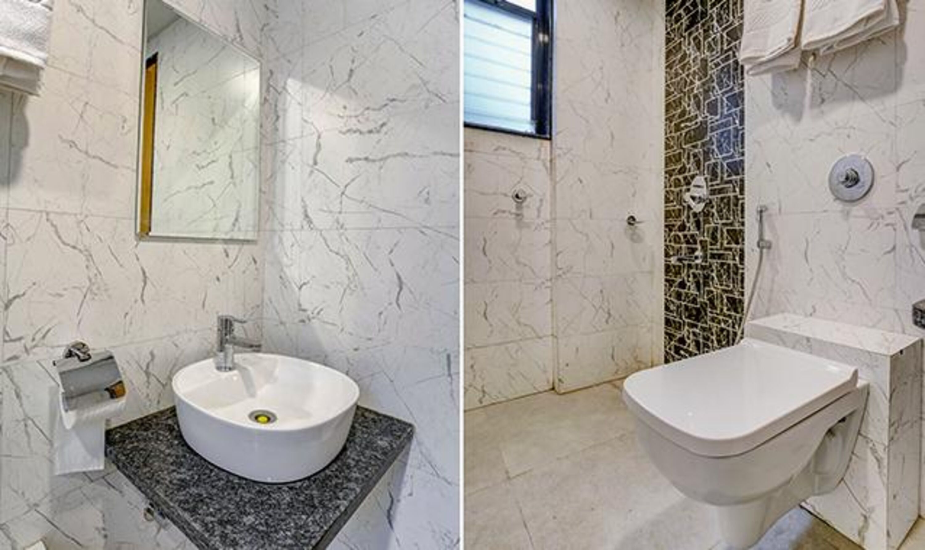 A bathroom with a marble sink, a toilet, and a shower area.