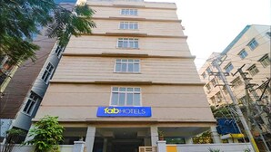 A multi-story building with a sign for 'fab hotels' at the ground level. - Fabhotel Stone Gallery (Hyderabad)