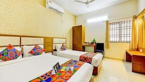 A hotel room with two beds, a desk, a chair, and a window with curtains. - Fabhotel Ruchikkoot Bay (Chennai)